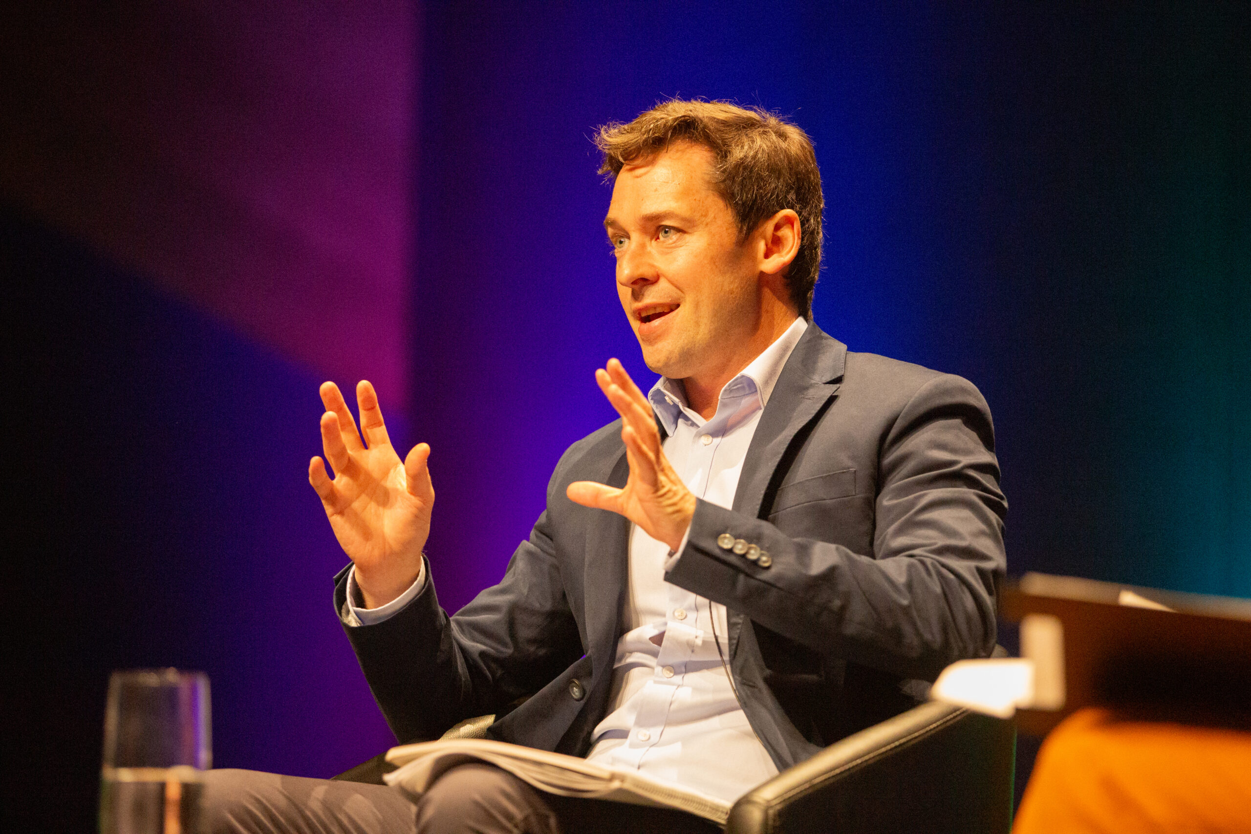 Nick McKenzie on stage at AHRI's National Convention and Exhibition