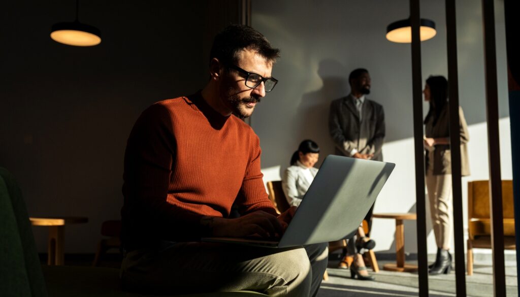 Image of a man on a laptop looking serious