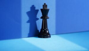 Black chess piece against a blue background