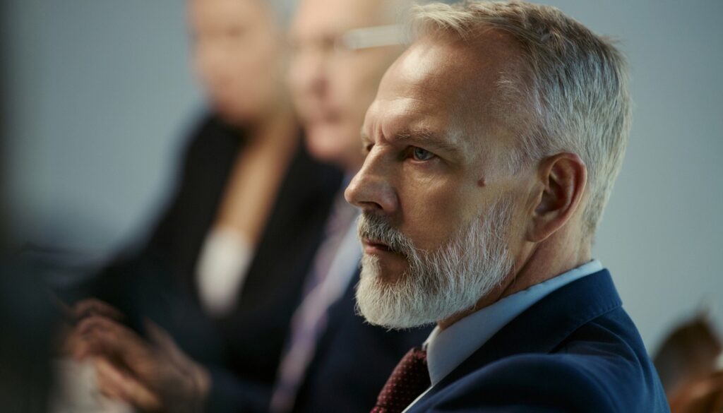 Serious looking older male leader