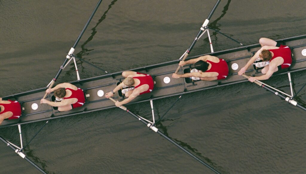 Aerial shot of men rowing on a long boat