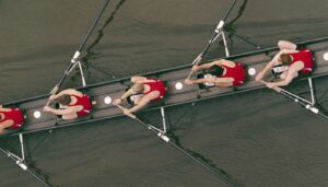 Aerial shot of men rowing on a long boat