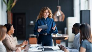Image of a woman addressing a board room