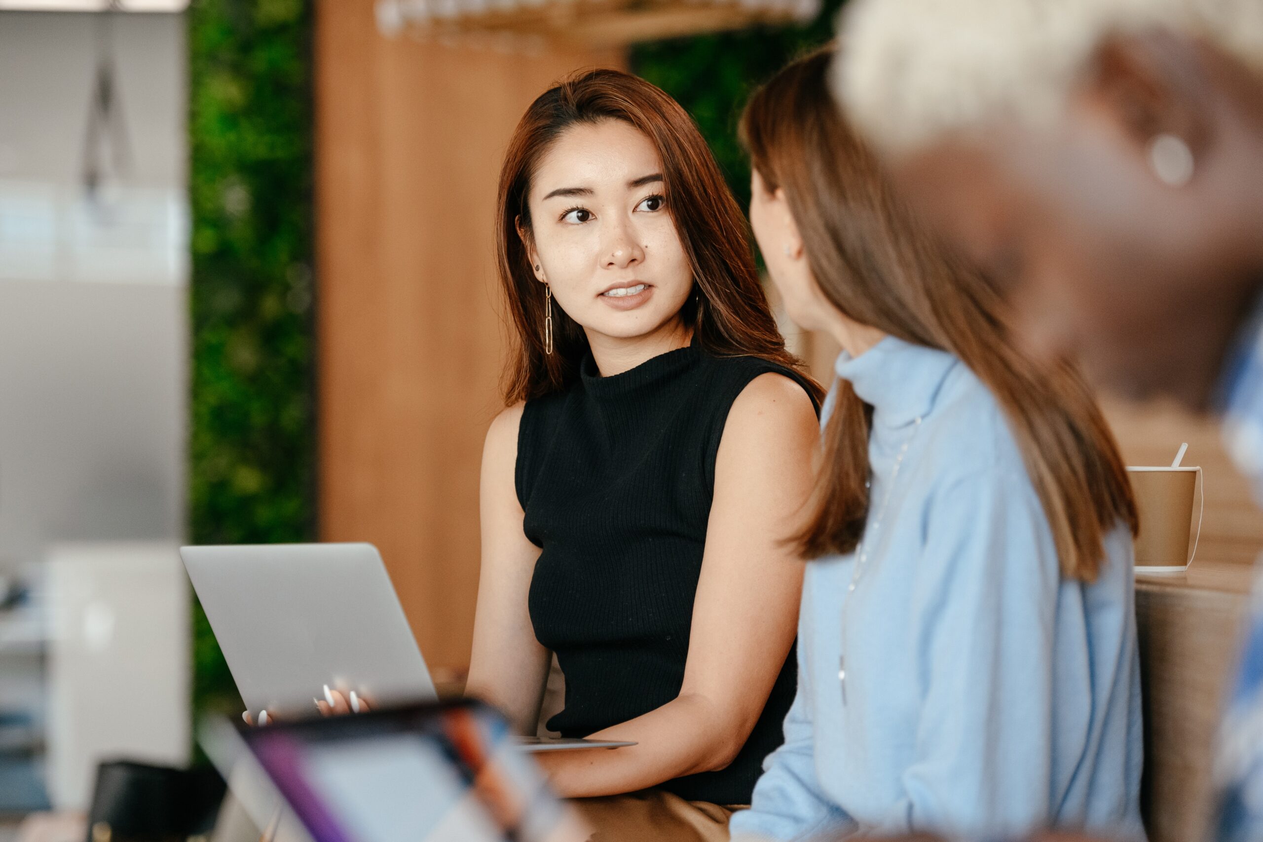 Photo of young woman looking slightly annoyed at coworker
