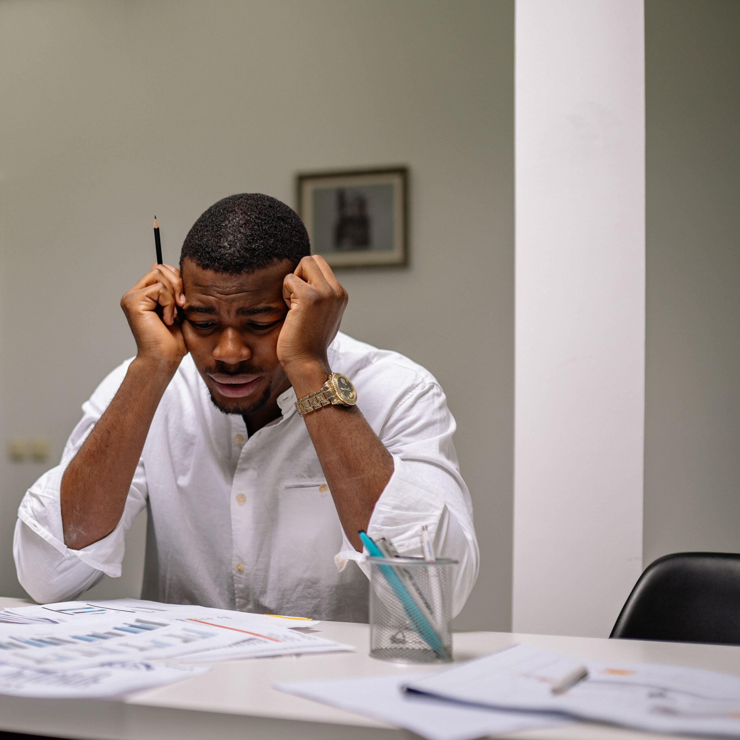 Frustrated man looking at paperwork